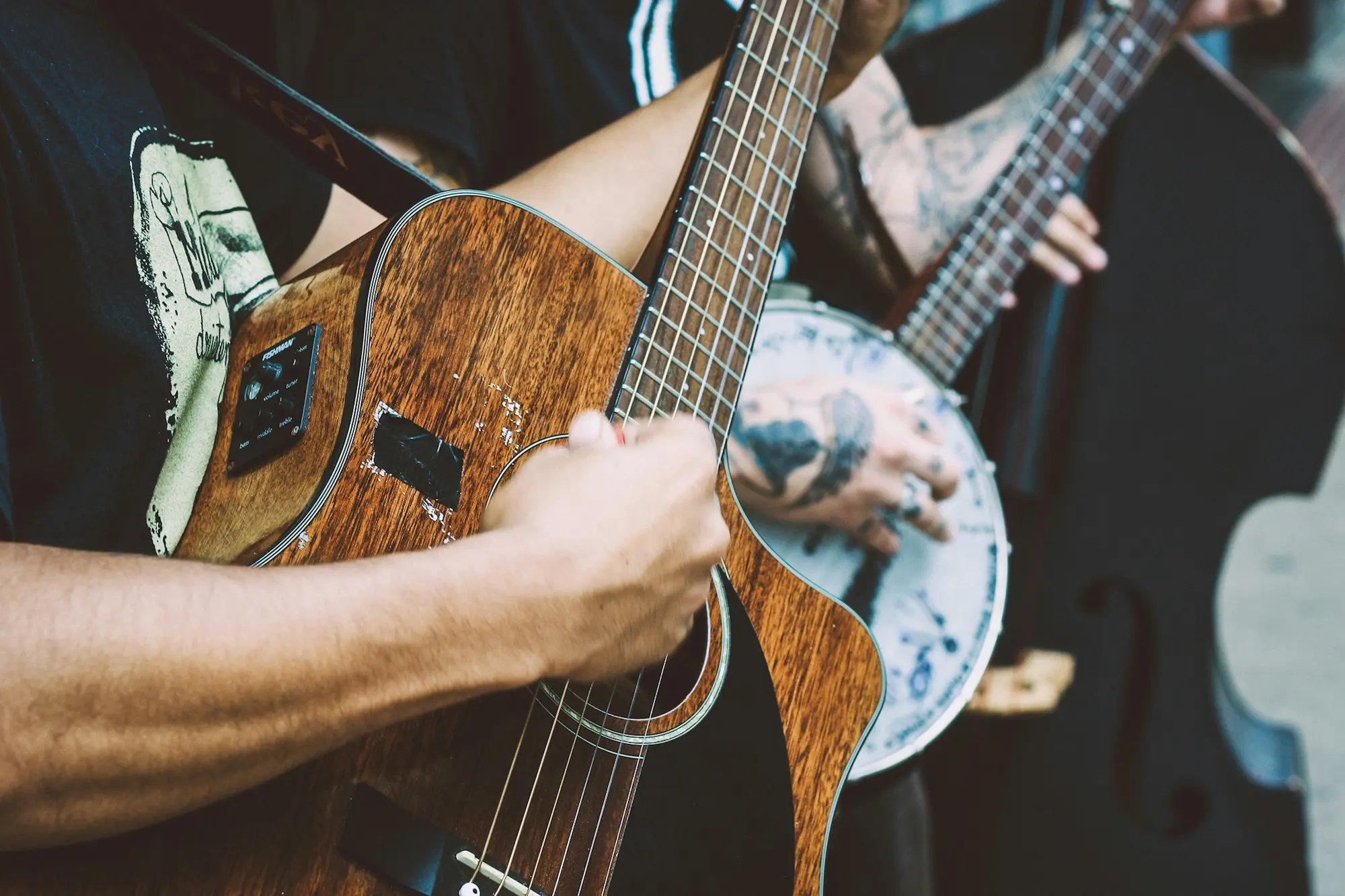 Photo by Matheus Ferrero on Unsplash of hands playing guitar.